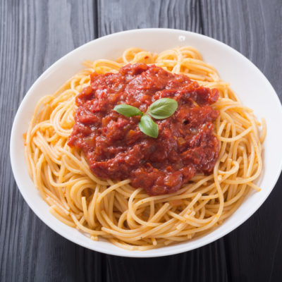 Italian pasta spaghetti with tomato sauce and basil